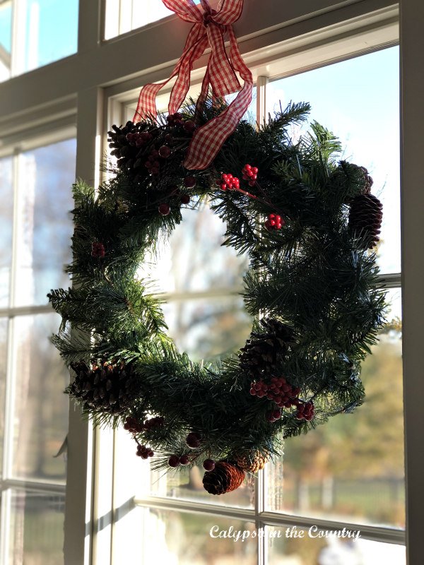 Rustic Pine Wreath with Pinecones and Berries in a Window — Christmas Window Wreaths