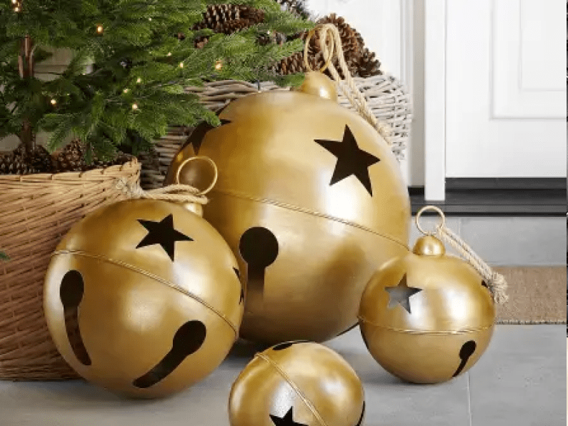 Oversized Gold Jingle Bells with Star Cutouts on a Porch Display Oversized Gold Jingle Bells with Star Cutouts on a Porch Display — Ornament Christmas Tree