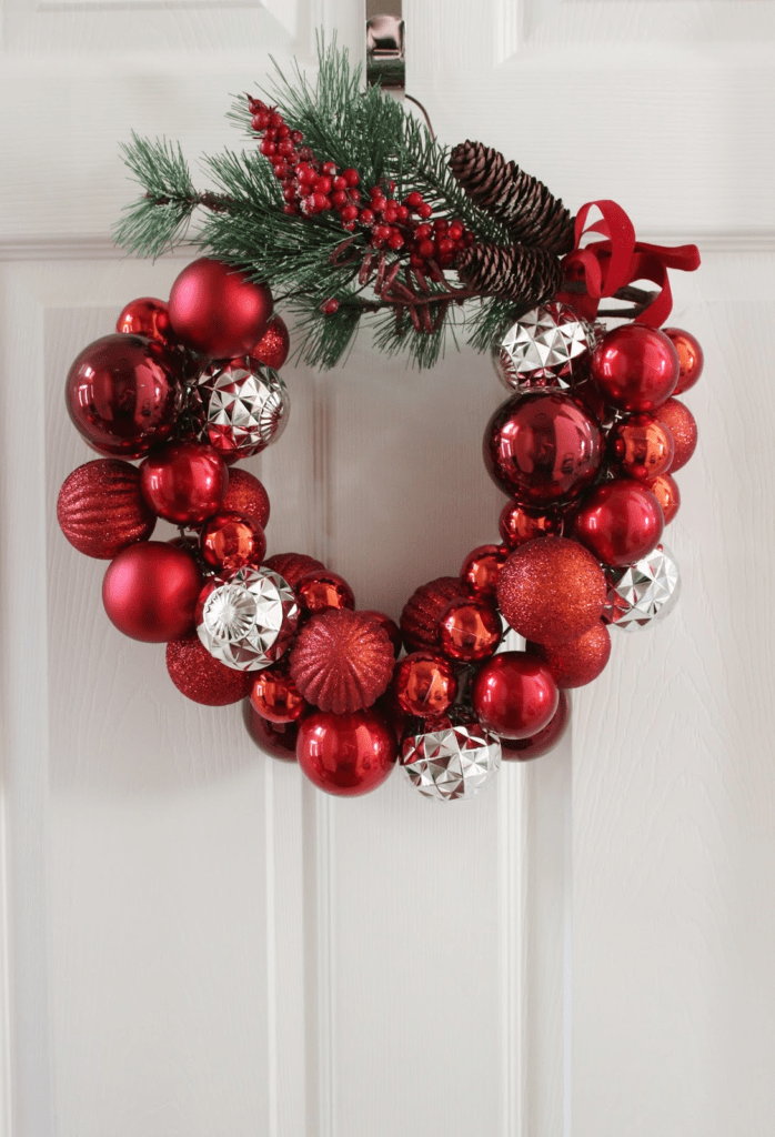 Traditional Ornament Wreath on a White Door with Natural Elements Traditional Ornament Wreath on a White Door with Natural Elements