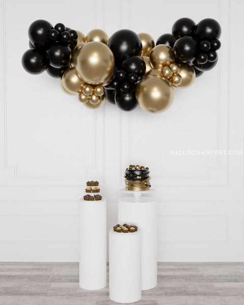 Modern Display with Black and Gold Balloon Garland and Dessert Pedestals Modern Display with Black and Gold Balloon Garland and Dessert Pedestals — New Years Eve Balloon Garland