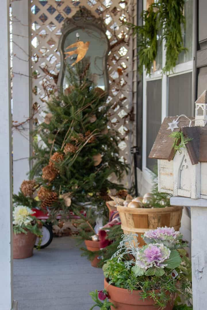 Farmhouse Porch with a Whimsical Decorated Christmas Tree Farmhouse Porch with a Whimsical Decorated Christmas Tree — Winter Porch Decor
