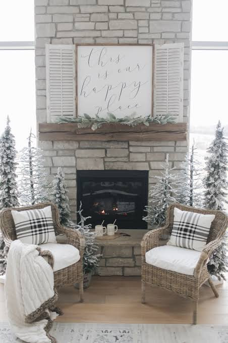 Rustic Stone Fireplace with Flocked Trees and Plaid Pillows Rustic Stone Fireplace with Flocked Trees and Plaid Pillows — Winter Home Decor