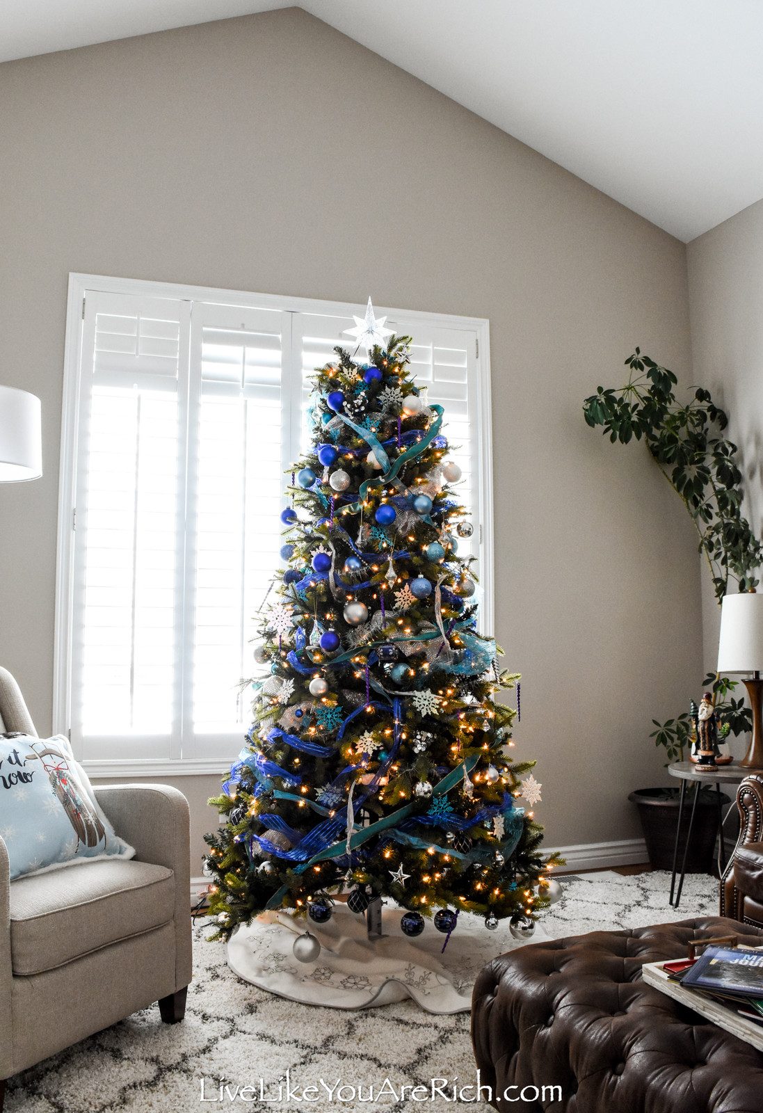 Traditional Blue and White Flocked Tree with Silver Ornaments and Ribbon Traditional Blue and White Flocked Tree with Silver Ornaments and Ribbon — Blue and Silver Christmas Tree