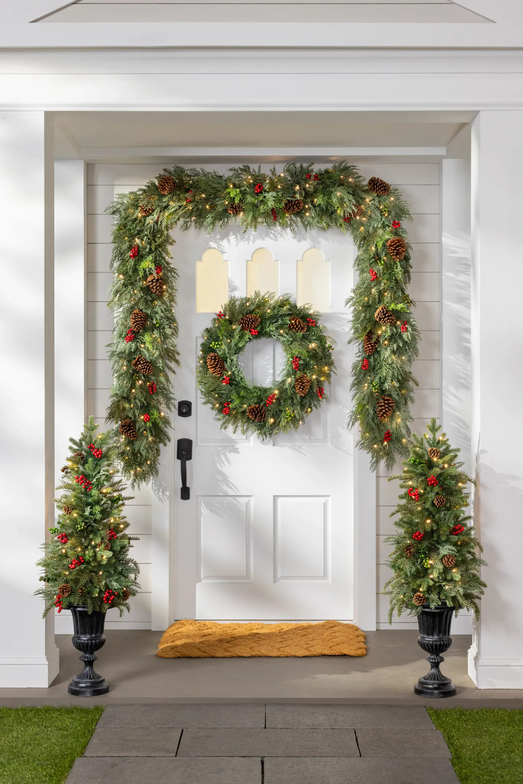 Grand Traditional Entrance with Evergreen Garland Arch Grand Traditional Entrance with Evergreen Garland Arch — Winter Front Door Decor