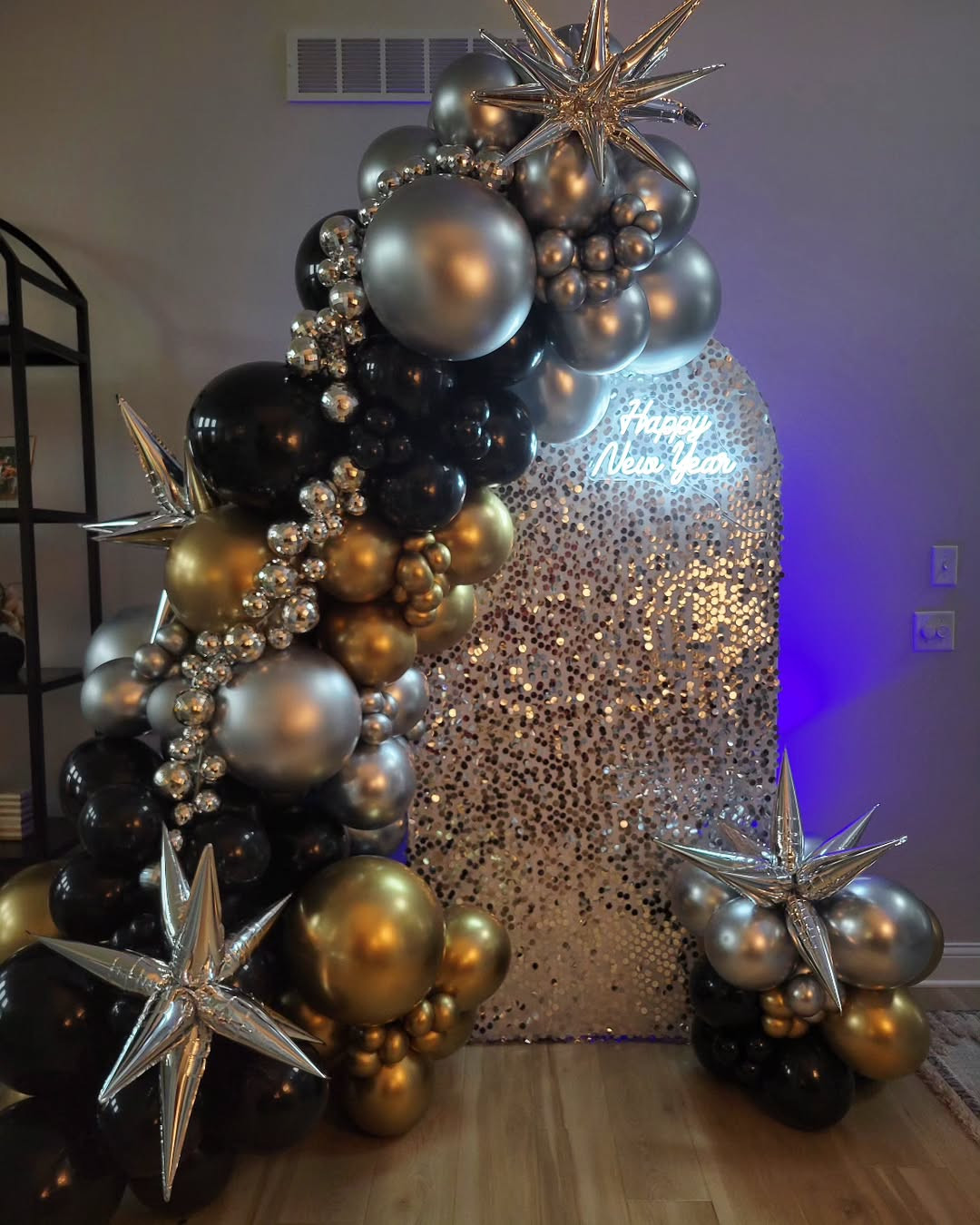 Indoor Party Scene with Black, Gold, and Silver Balloon Garland and Neon Sign Indoor Party Scene with Black, Gold, and Silver Balloon Garland and Neon Sign — New Years Eve Balloon Garland