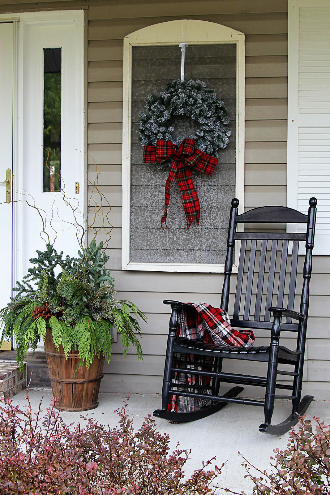Farmhouse Rocking Chair with Plaid Blanket and Greenery Farmhouse Rocking Chair with Plaid Blanket and Greenery — Winter Porch Decor