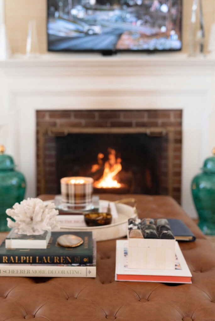 Ottoman Display with Books and Candle by Fireplace Ottoman Display with Books and Candle by Fireplace — Winter Home Decor