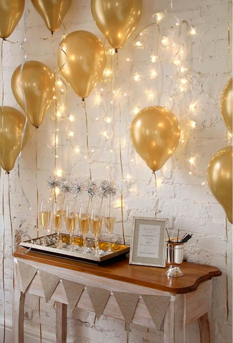 Festive Table Setting with Gold Balloons and Sparkling String Lights — New Years Eve Party Decor