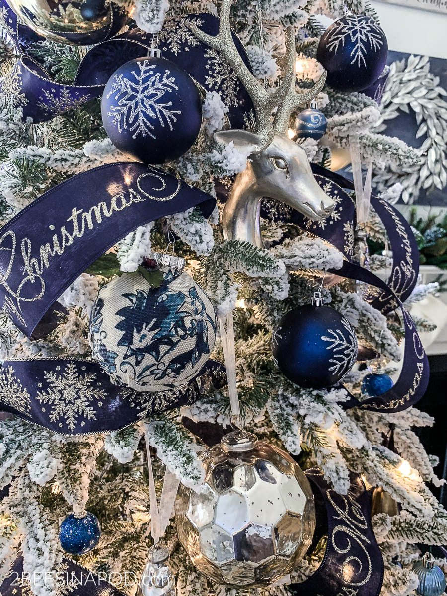Living Room Flocked Tree with Blue/Silver Ornaments and Velvet Ribbons Living Room Flocked Tree with Blue/Silver Ornaments and Velvet Ribbons — Blue and Silver Christmas Tree