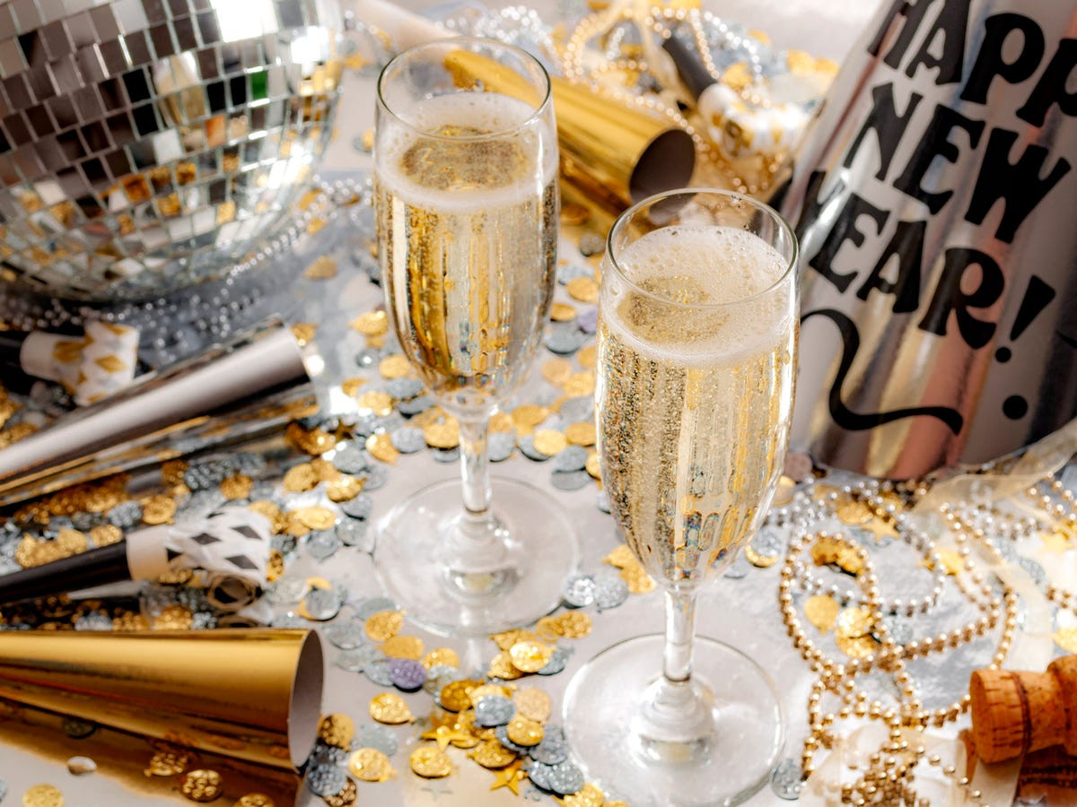 Glamorous Champagne Glasses and Disco Ball with Scattered Confetti — New Years Eve Party Decor