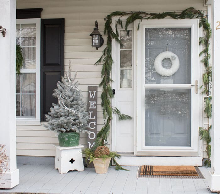Farmhouse Charm with Flocked Tree and Wreath on Screen Door Farmhouse Charm with Flocked Tree and Wreath on Screen Door — Winter Front Door Decor