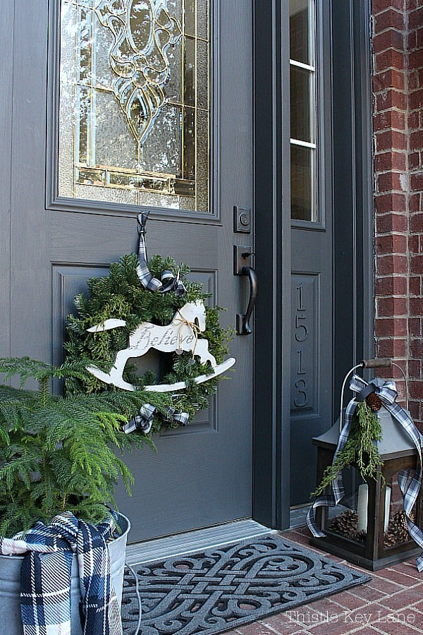 Cozy Traditional Door with Rocking Horse Wreath Accent Cozy Traditional Door with Rocking Horse Wreath Accent — Winter Front Door Decor