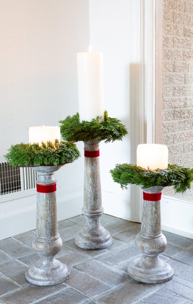 Rustic Farmhouse Entryway Candle Holders with Wreaths and Red Ribbon Rustic Farmhouse Entryway Candle Holders with Wreaths and Red Ribbon — Christmas Candle Decor