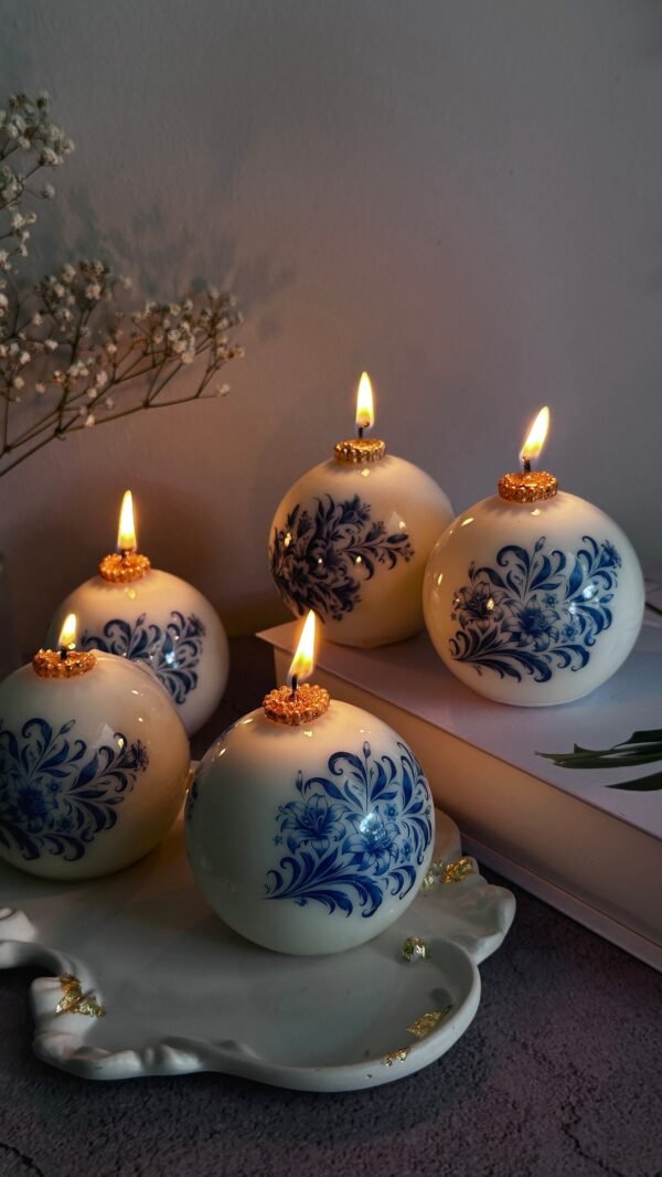Elegant Spherical Candles with Blue Floral Patterns on a Tray Elegant Spherical Candles with Blue Floral Patterns on a Tray — Christmas Candle Decor