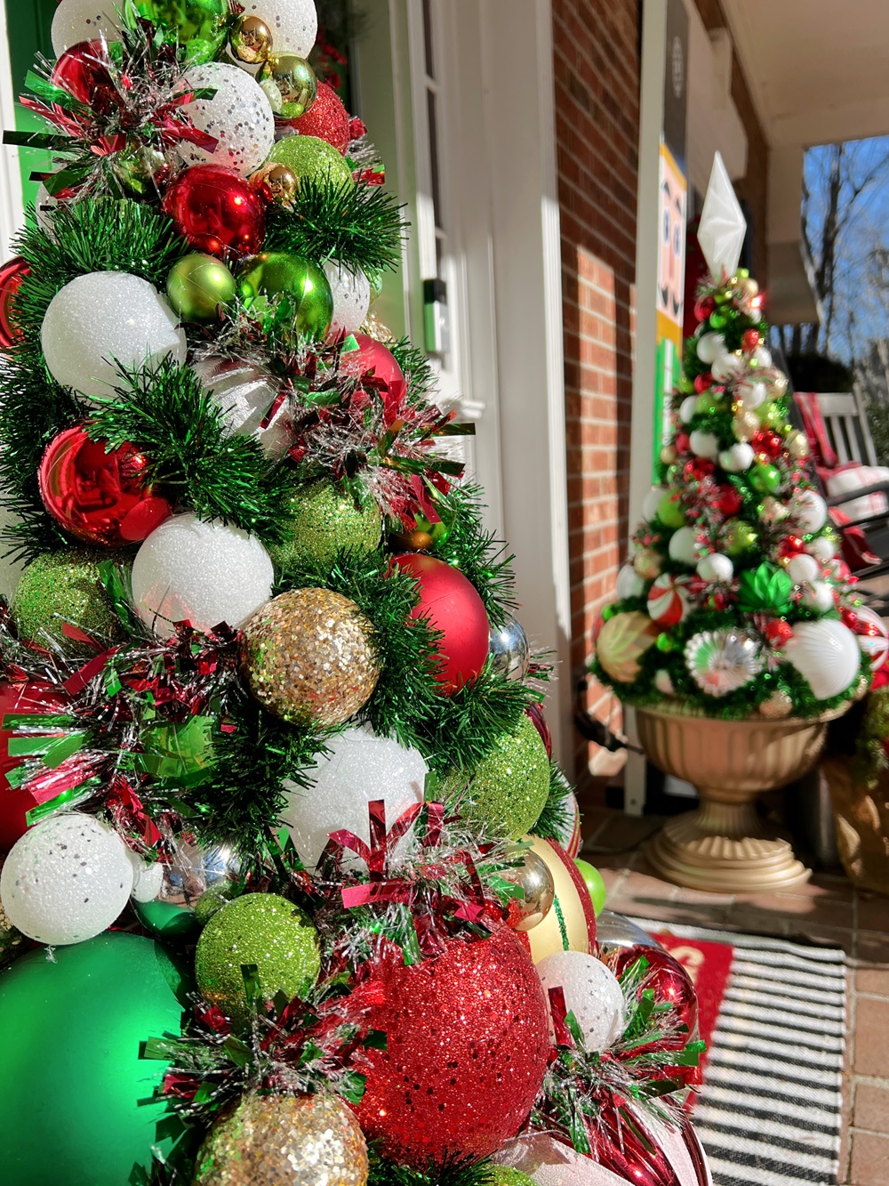 Outdoor Porch Christmas Trees in Ornate Urns Outdoor Porch Christmas Trees in Ornate Urns — Red and Green Christmas Tree